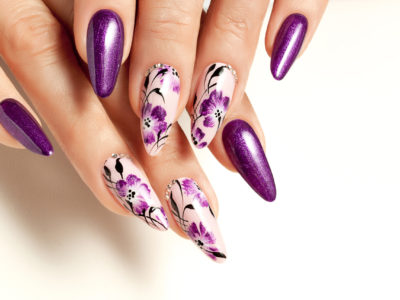 Nail art service. Female manicure and floral patterns.