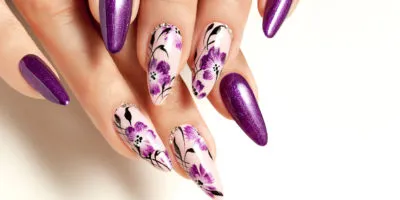 Nail art service. Female manicure and floral patterns.